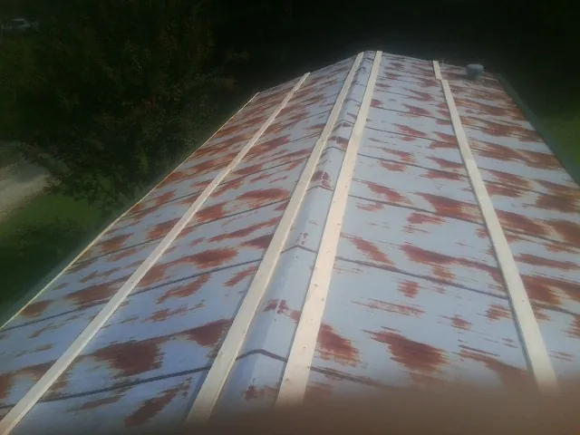 Rusted metal roof panels with new wood purlins before replacement — Storm Damage Roof Repair in Staten Island by Roofing Brothers